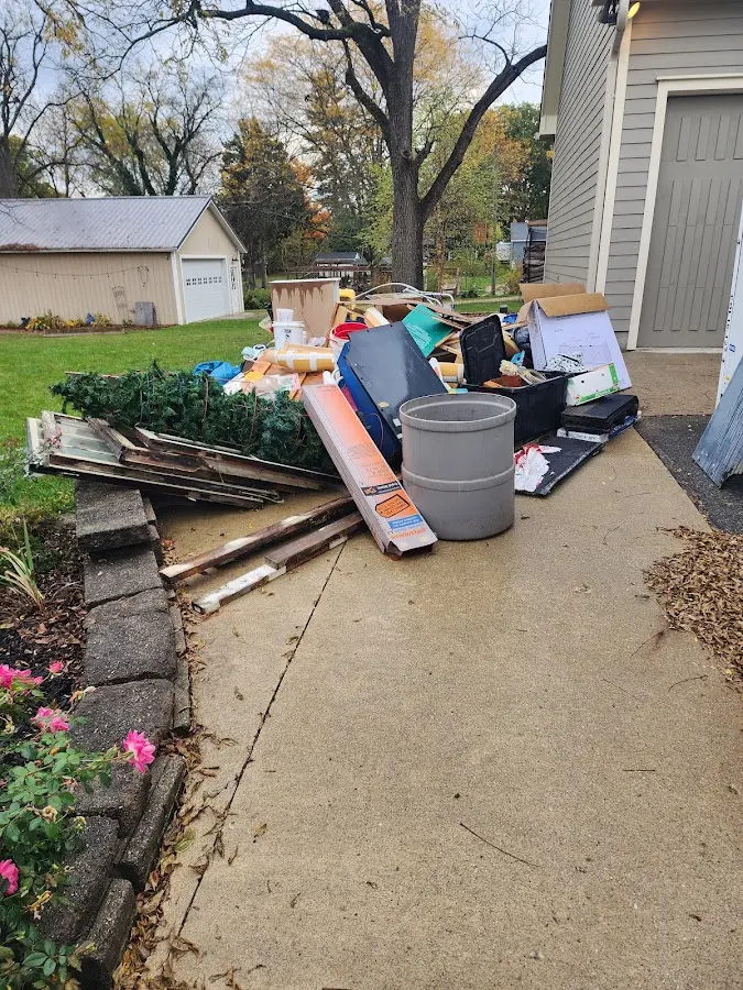 Dumpster being loaded with debris for Roofing Dumpster Rental in Rhinelander